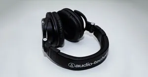 A pair of closed-back headphones with a white background.