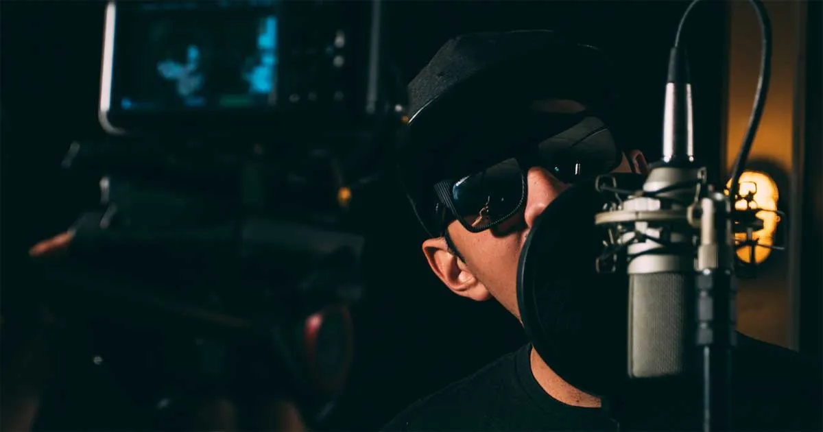 A man recording a vocal performance using a microphone.
