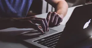 A person working on their MacBook Pro.