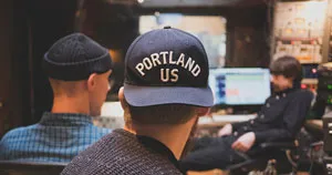 Two music producers hanging out in a studio.