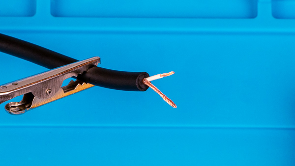An image of an instrument cable with the inner "hot" wire stripped.