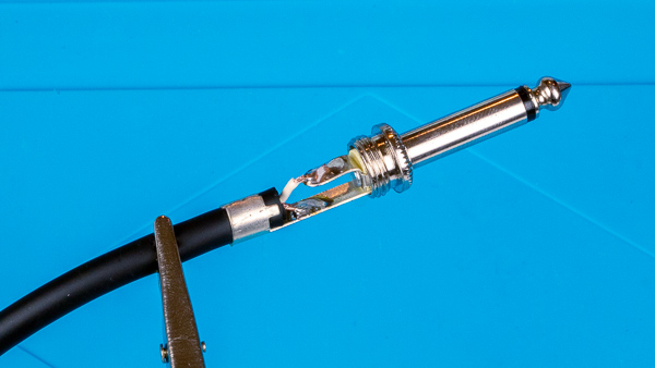 An image of an instrument cable soldered to a 1/4" TS phone plug.