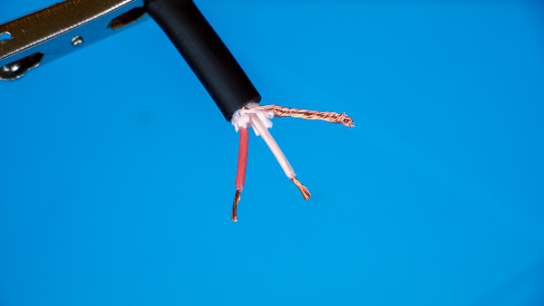 An image of a microphone cable's stripped "hot" and "cold" wires.