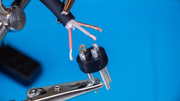 An image of a microphone cable lined up with the pins of a male XLR connector.