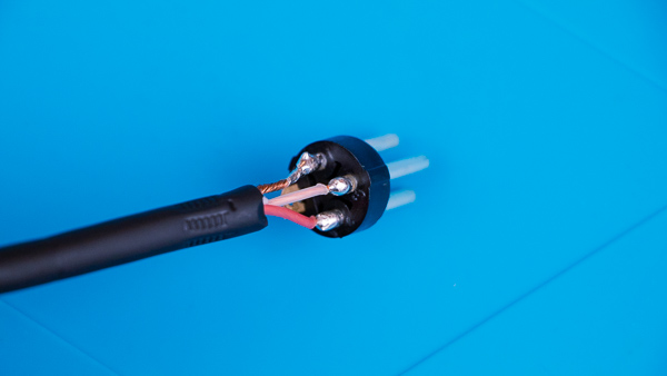 An image of a microphone cable soldered to the pins of a male XLR connector.