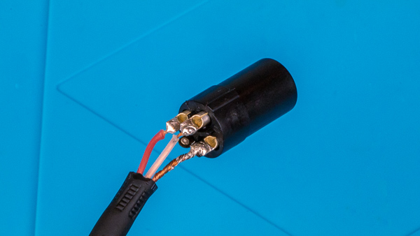 An image of a microphone cable soldered to the pins of a female XLR connector.