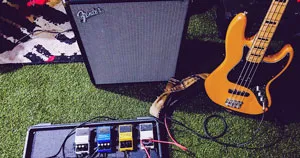 Guitar pedals, a guitar amp, and an electric guitar.