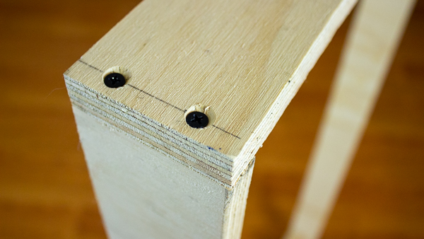 An image of a completed joint, held together with wood glue and two wood screws.