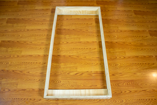 A front view of two support strips added to an acoustic panel frame.