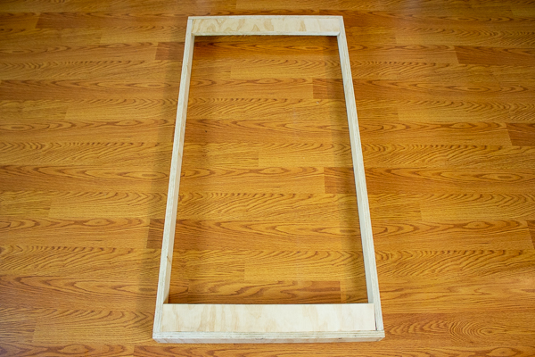 A rear view of two support strips added to an acoustic panel frame.