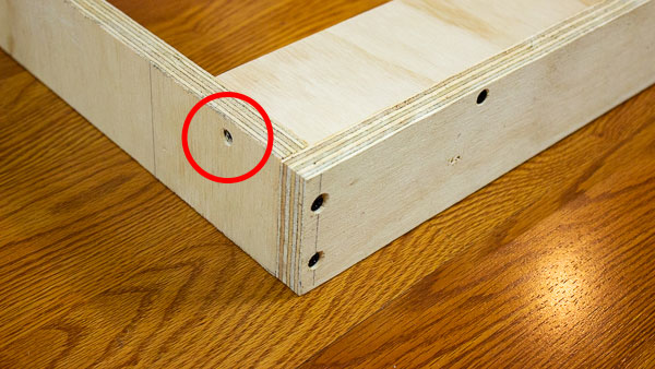 An image of additional stabilization added to a support strip using wood glue and a wood screw (red).