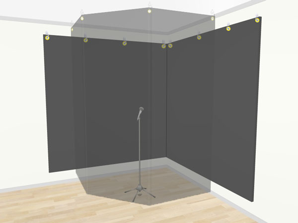 An image of a vocal recording booth set up in the corner of a room.