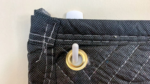 An image of a grommet hanging from a Command hook.