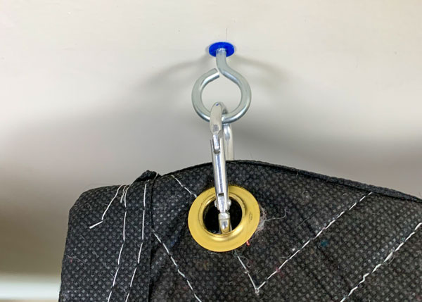 An image of a grommet latched into a carabiner.