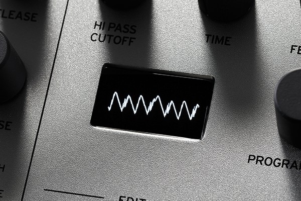 An image of the Minilogue's multi-purpose OLED screen displaying a waveform.