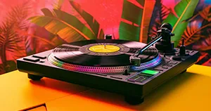 An image of a colorful turntable sitting on a yellow table.