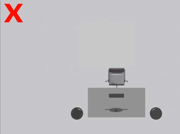 A picture of a desk incorrectly placed asymmetrically in a studio.